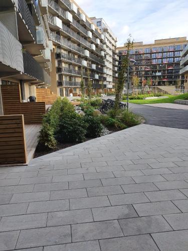 a sidewalk in front of a large apartment building at The Golden Park in Oslo