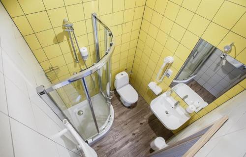 a bathroom with a toilet and a sink and a mirror at Safestay Warsaw Old Town in Warsaw