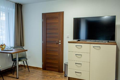 a room with a television on top of a dresser at Penzión LABA in Trebišov