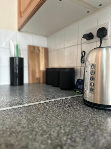 a toaster sitting on top of a counter in a kitchen at 1 Bedroom Apartment By Guest Nest Management Vacation Rental Brighton - Pet-Friendly in Brighton & Hove