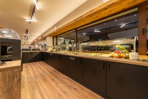 a kitchen with a counter with some food at Riserva Bianca Limone Hotel & SPA in Limone Piemonte