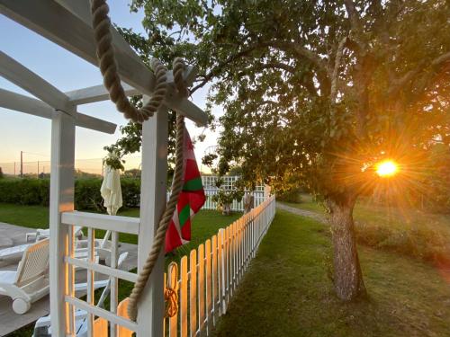 a house with a fence and a tree and a flag at CHATEAU ROUTGER in Sainte Marie de Gosse