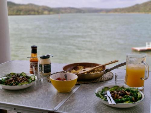 una tavola con piatti di cibo e un bicchiere di succo d'arancia di Hacienda de la Cruz ad Ayamonte