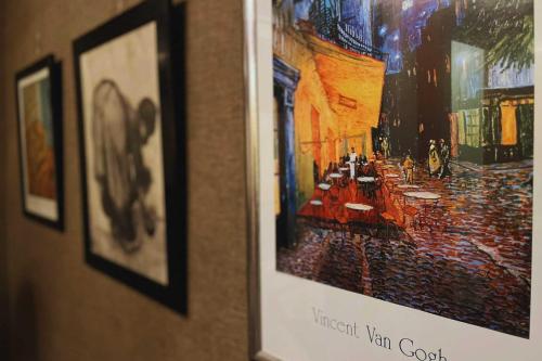 a picture hanging on a wall with a picture at Van Gogh Huis Medemblik in Medemblik