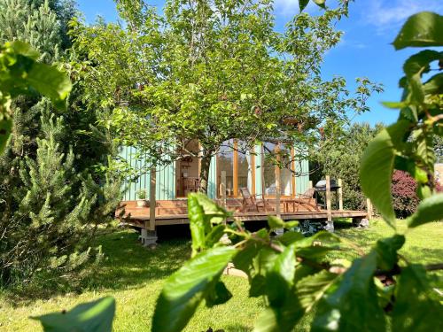 a tree house in the middle of a yard at Sakura Tiny house in National park,salty pool in Staré Křečany