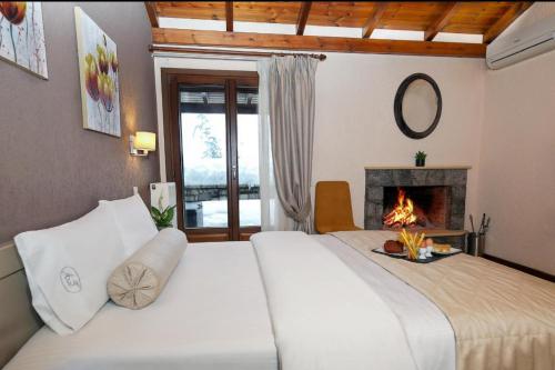 a bedroom with a large bed with a fireplace at Asimina Guesthouse, Eptalofos Parnassos in Eptalofos