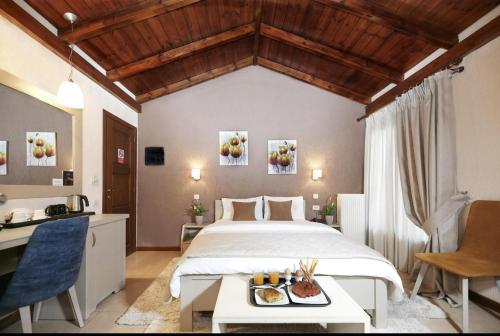 a bedroom with a bed with a tray of food on it at Asimina Guesthouse, Eptalofos Parnassos in Eptalofos