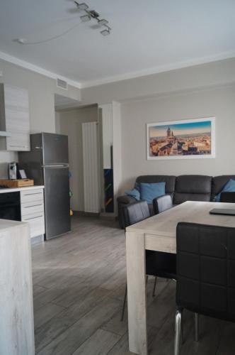 a kitchen and living room with a couch and a table at BGY Central Apartments in Bergamo