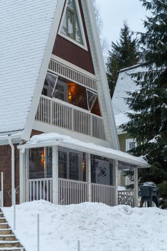 a large house with snow on the ground at Двокімнатний апартамент на увесь перший поверх котеджу Freeman-3а - це ЧАСТИНА БУДИНКУ з окремим входом - є камін, велика тераса, гриль in Bukovel