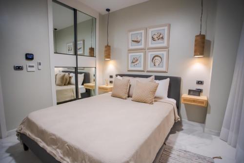a bedroom with a large white bed with two pillows at Xeliter Cana Rock Punta Cana in Punta Cana