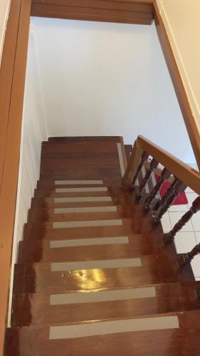 a wooden stairway with a window in a building at Aimei Bang Saray in Bang Sare