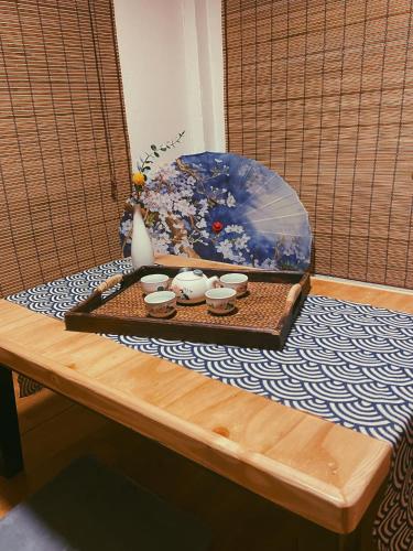 a table with cups and an umbrella on it at Aimei Bang Saray in Bang Sare
