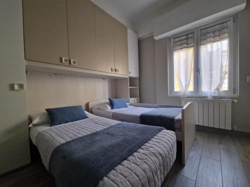 a bedroom with two beds and a window at BGY Central Apartments in Bergamo