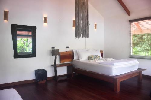 a bedroom with a bed and a mirror in it at The Jaguars Jungle Rainforest Lodge - All meals included in San Pedrillo