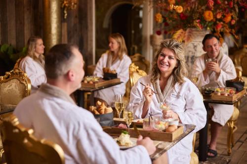 a group of people sitting at a table with food at Wellnessresort & Hotel De Valkenberg in Rheden
