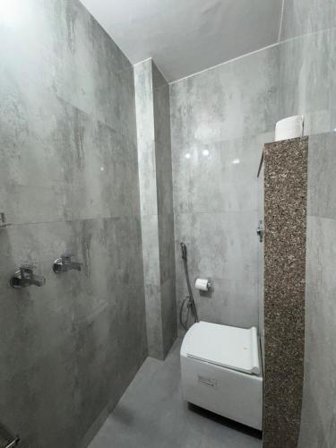a bathroom with a white toilet in a room at Pacho Luxe- 2 Bedroom Luxury Independent Villa in Jaipur