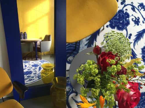 a room with a table with a vase of flowers at Het Blauwe Uur in Nijmegen