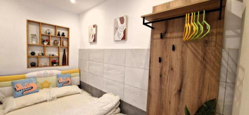 a room with a couch and a wooden door at Quiet Studio with Athens View in Athens