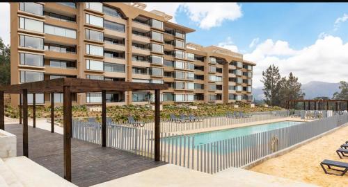 an image of a hotel with a swimming pool at Departamento impecable en santa Augusta, Quintay - 6 personas in Quintay