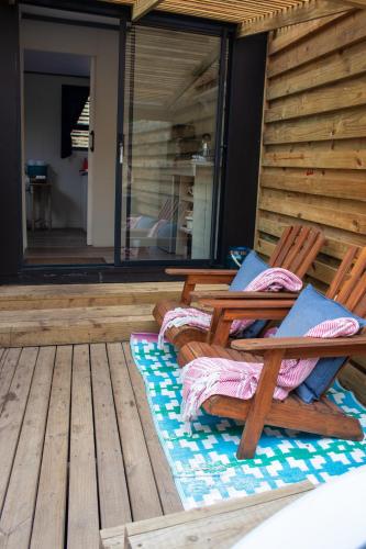 two wooden chairs sitting on a wooden deck at The Forest Dome Tsitsikamma in Stormsriviermond