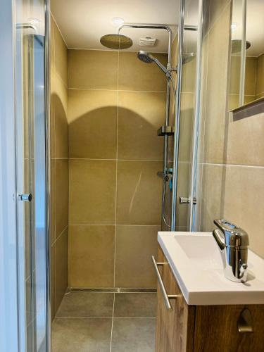 a bathroom with a shower and a sink at Ocean Breeze - Noordwijk aan Zee in Noordwijk aan Zee