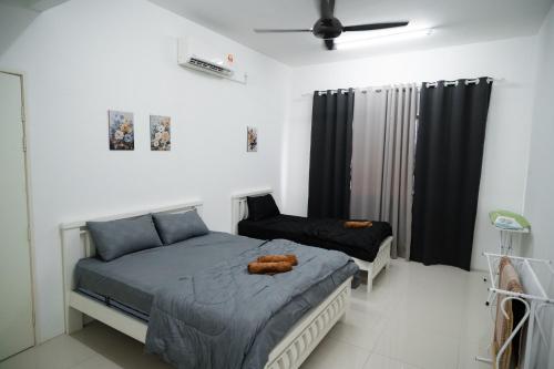 a bedroom with a bed and a chair at Melati Homestay in Kuala Terengganu