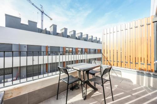 a balcony with a table and chairs on a building at Elegant Studio with Private Terrace by RentitUP in San Sebastián de los Reyes