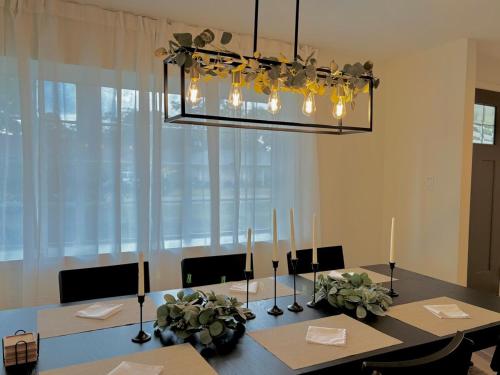 a dining room with a long table and a chandelier at King Bed Suite in Conroe , Garage Available in Conroe
