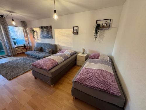 a living room with two beds and a couch at Apartment am Messegelände in Nürnberg