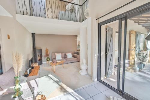 un salon avec un canapé et une table dans l'établissement Slow Villa, 5 chambres avec piscine, à Pérols