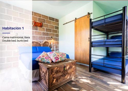 a room with a bunk bed and a wooden trunk at Cozy House with Pool and 3 Bedrooms in Yautepec