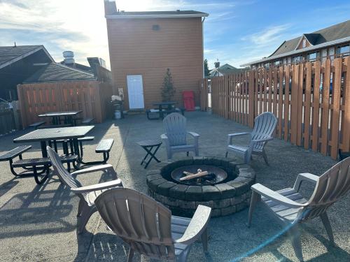 a patio with chairs and a fire pit and a table at Inn at the Sea in Long Beach