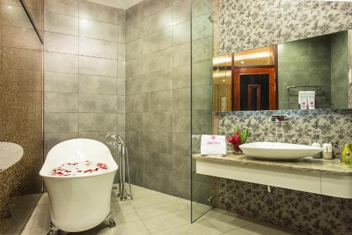 a bathroom with a toilet and a sink and a mirror at Valentine Hotel in Ho Chi Minh City