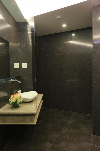 a bathroom with a sink and a mirror at Valentine Hotel in Ho Chi Minh City