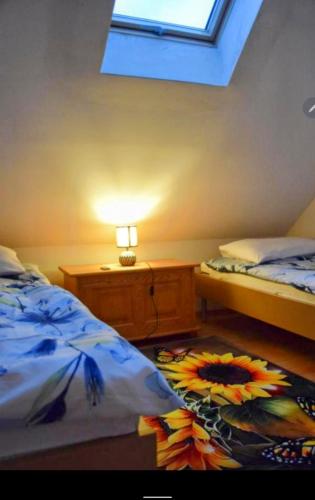 a bedroom with two beds and a lamp and a window at Salt Mine Apartment Bochnia by OTH in Bochnia