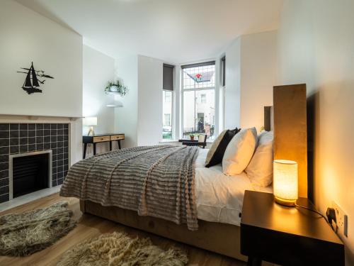 a bedroom with a large bed and a fireplace at Bohemian Apartment, free WiFi and parking in New Brighton