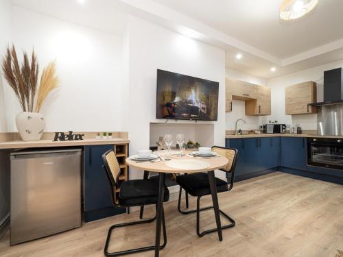 a kitchen and dining room with a table and chairs at Bohemian Apartment, free WiFi and parking in New Brighton