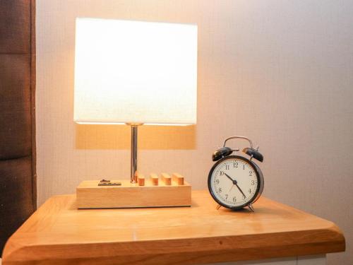 a clock sitting on a table next to a lamp at The Steading in Dumfries