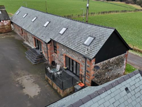 an aerial view of a house in a body of water at The Steading in Dumfries