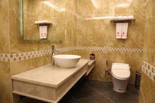 a bathroom with a sink and a toilet at Valentine Hotel in Ho Chi Minh City