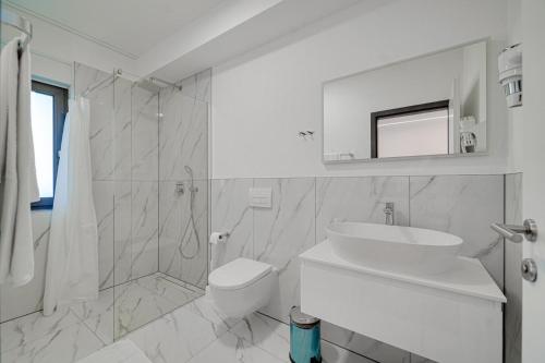a bathroom with a sink and a toilet and a shower at Villa Laura in Funtana