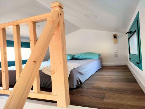 a bedroom with a bunk bed and a ladder at Tiny Haus Komos in Pitsidia