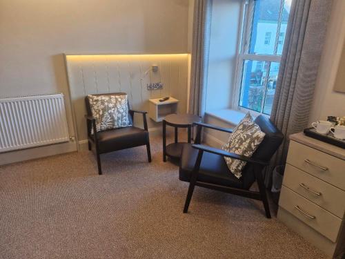 a room with two chairs and a table and a window at The Quay lodge in Wexford