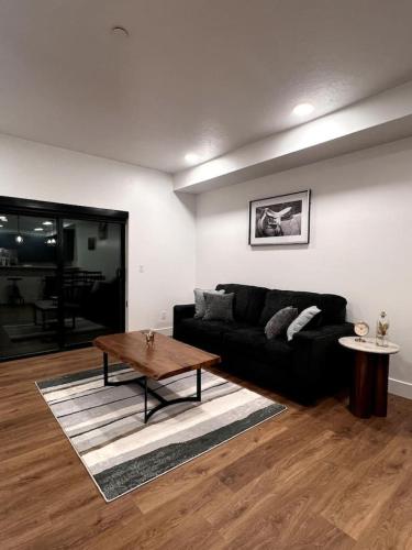 a living room with a black couch and a table at Affordable Comfort in Juneau 206 in Juneau