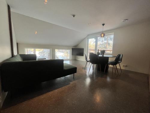 a living room with a couch and a table at B2 Lakeside Suite Polku Hotel in Vihti