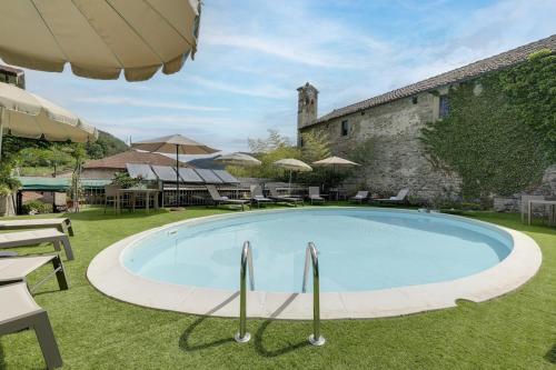 a large swimming pool in the yard of a building at My Exclusive Italy - Entire Hilltop Villa with Private Pool in Palazzuolo sul Senio
