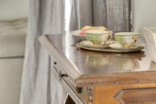 a table with two cups and plates on it at My Exclusive Italy - Entire Hilltop Villa with Private Pool in Palazzuolo sul Senio