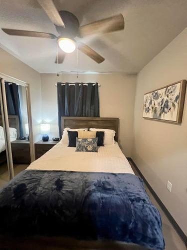 a bedroom with a bed with a ceiling fan at Home Sweet Stay in Clovis