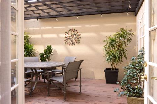 a patio with a table and chairs and potted plants at Hotel Roanoke & Conference Center, Curio Collection by Hilton in Roanoke