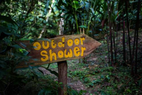a sign in the middle of a forest at Omega Tours Eco-Jungle Lodge in La Ceiba